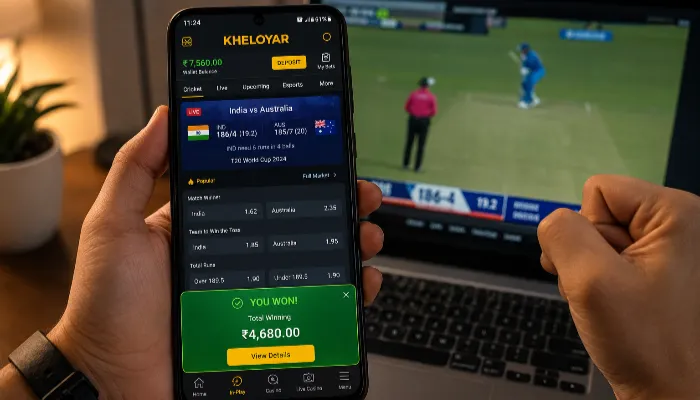 Person using Kheloyar betting app on smartphone during live cricket betting session